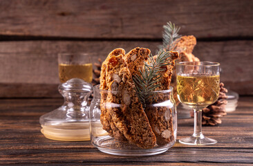 Traditional italian Christmas New Year dry cookies biscuits biscotti cantuccini in glass bowl on wooden background. Biscotti di Prato