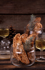 Traditional italian Christmas New Year dry cookies biscuits biscotti cantuccini in glass bowl on wooden background. Biscotti di Prato