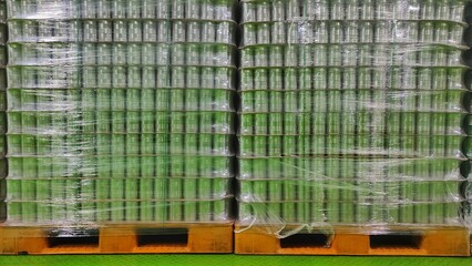Aluminum empty can covered with plastic on pallet in warehouse to keep it clean before used for...