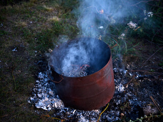 Burning garbage in the tank. Incineration of garbage in an iron bucket. Flames.
