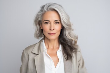Fototapeta premium Portrait of mature beautiful woman with grey hairstyle and white top