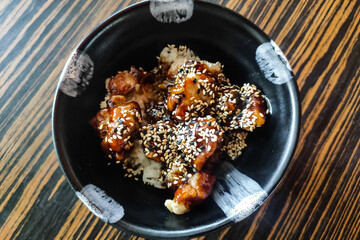 chicken in teriyaki sauces with rice and sesame seeds