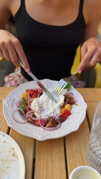A girl is savoring the taste of burrata cheese in a restaurant.