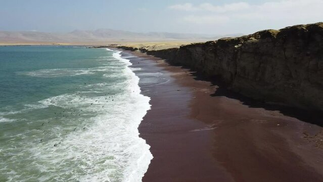 amazing aerial view of the paracas red beach south from Lima with birds flying