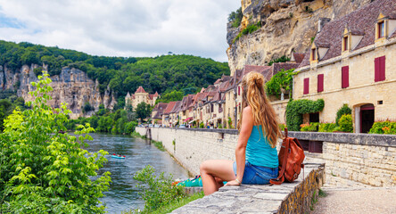 Woman tourist enjoying view of famous village of La Roque Gageac in France- Dordogne, Perigord