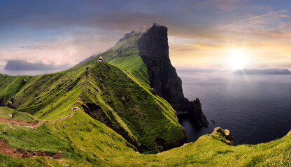 Sunset over green mountain with atlantic ocean, Faroe islands - Kallur lighthouse - 634028004