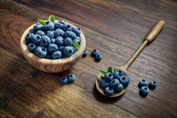 Blueberry antioxidant organic superfood in bowl and on wooden spoon