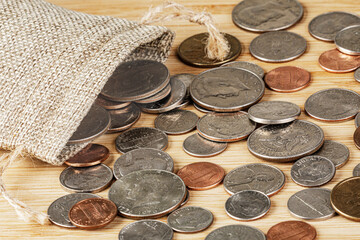American Coins spilling out of a Burlap Bag