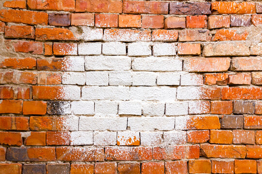 White lime splashed on a red brick wall, stain