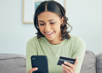 Credit card, phone and woman on a sofa happy for cashback, savings or ecommerce sale in her home. Smartphone, and female customer in a living room smile for sign up, survey or bank, payment or budget