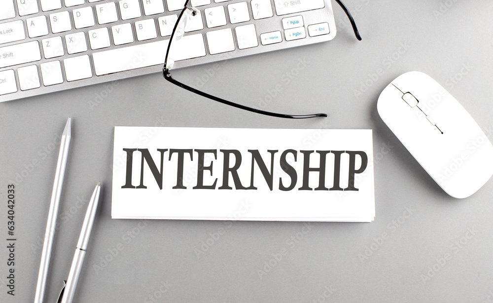 Poster internship text on paper with keyboard on grey background