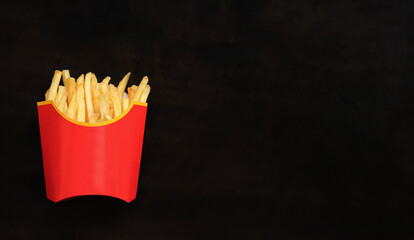 French fries on a dark wooden background, top view. Empty space for text. Copy space