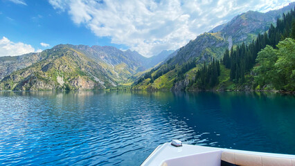 Boat trip on the beautiful mountain lake of Sary Chelek. The State Biosphere Reserve is a specially protected natural territory of Kyrgyzstan.