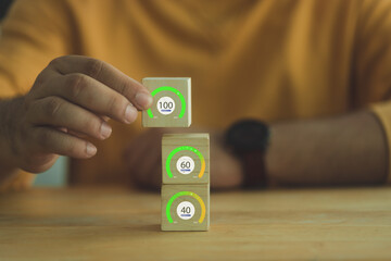 Increasing percentage rate concept. The man put wood block from the timeline at 40, 60 to 100...