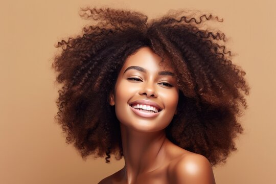 beautiful african american girl with wavy black hair, cosmetics and makeup concept