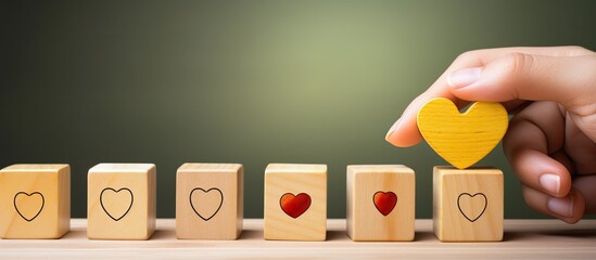 Using wooden cubes a banner symbolizes CRM or customer loyalty programs that focus on customer satisfaction and retention strategies