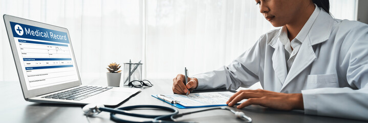 Doctor carefully review detailed medical report on laptop and diagnosing illness for effective...