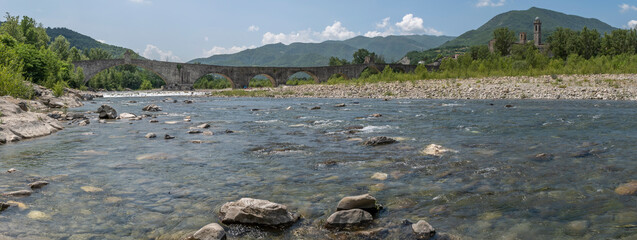 Panoramic view of ancient Ponte Gobbo bridge over the Trebbia river, Bobbio, Piacenza, Italy