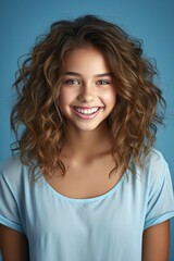 Fototapeta premium smiling beautiful teen girl portrait on blue background