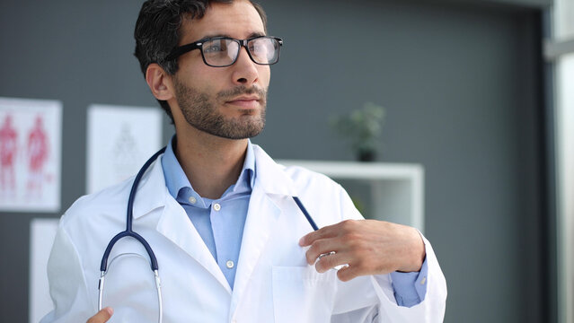 Pensive doctor with looking away to reflections on diagnosis