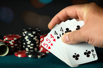 Poker cards with a full house or full boat combination in the player hand. Winning combination in a...