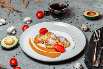 Sweet delicious food for breakfast. Pancake cheesecakes with fresh strawberry, blueberry and maple syrup. Delicious tasty pancake, morning food in cafe. 