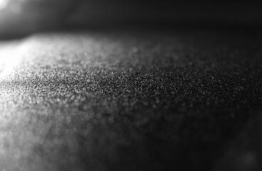 Rough leather surface with reflective white color. perspective and black background