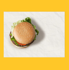 Mockup for fast food branding , top-view wrapping paper placemat. Hamburger placed on your custom-branded wrapping paper. Design and delicious capture from the top for a striking presentation