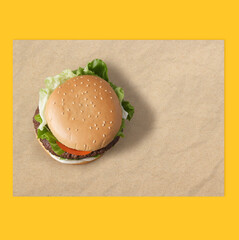 Mockup for fast food branding , top-view wrapping paper placemat. Hamburger placed on your custom-branded wrapping paper. Design and delicious capture from the top for a striking presentation