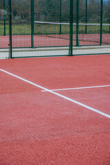 detail of the line of a red paddle tennis court, racket sports courts concept