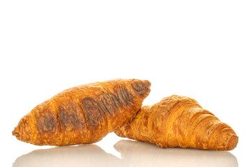 Two fragrant croissants with chocolate filling, close-up, isolated on white.