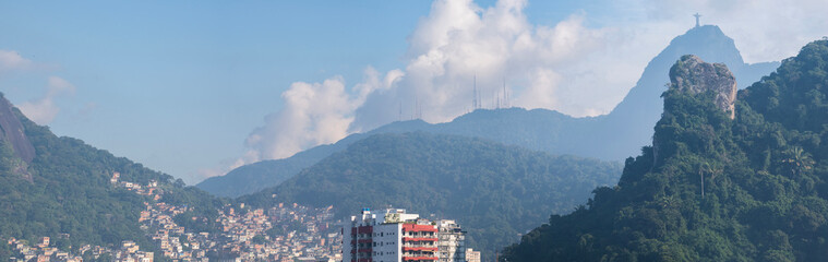 Brazil: skyline of Rio de Janeiro with the Rocinha favela, green vegetation and view of the Mount...