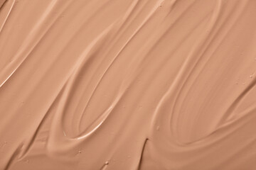 The base of the foundation is smeared as a sample background close-up. Makeup cosmetics. Concealer. Concealer texture.