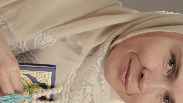 Muslim woman with quran and beads