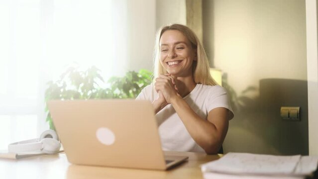 Positive tired young blond woman feels satisfied with distance remote work well done at light home Calm self employee female relax after hard working day finished project on laptop computer indoors