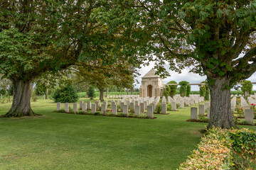 Ryes, France - 07 24 2023: Bazenville British Military Cemetery. View of Memorial and the white...