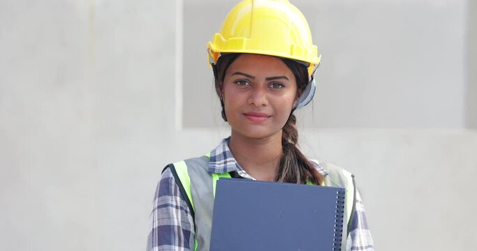 slow motion Portrait Asian indian female Engineer factory. Engineering worker in safety hardhat at factory industrial facilities. Heavy Industry Manufacturing. Prefabricated concrete walls