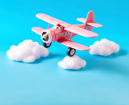 Toy aeroplane flying above cotton clouds. Carbon emissions conceptual background. AI generated image