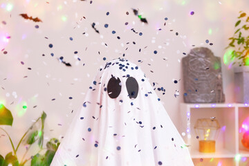 White ghost costume for Halloween party with neon lights in the background. The ghost is...