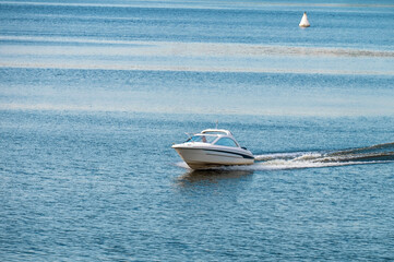 The motorboat is moving fast on the water.