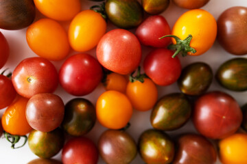 Colorful cherry tomatoes on white background. Close up. Selective focus.