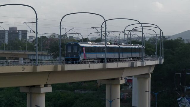 Metro runs on an overhead track, Vehicle moves along the Pune metro rail road near Sangam Bridge, now the Indian urban mass transit metro railway system. Pune, Maharashtra, India.