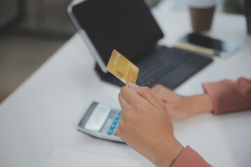 .Women holding credit card and using smartphones at home.Online shopping, internet banking, store...