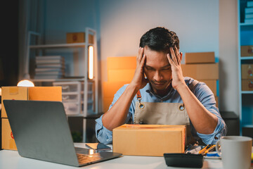 Young male entrepreneur stressed out at poor sales Concept of business man doing e-commerce business on website and social media Sell ​​products online.