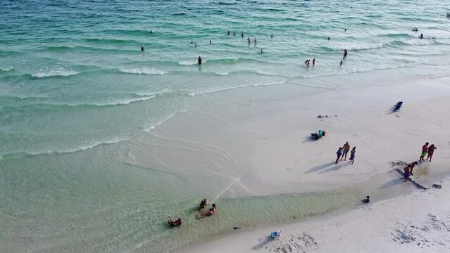 Families enjoy swimming, kids playing with white sandy, clean clear turquoise water, gentle waves along quiet Emerald Coast, Seagrove beach, Santa Rosa, Florida, USA