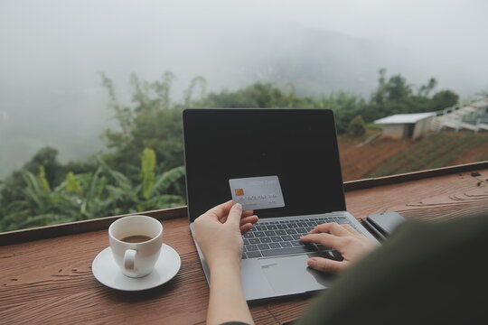 online payment, young woman holding credit card and touching on smartphone screen, copy space