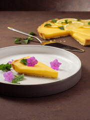 Classic lemon tart on a brown table. Copy space.