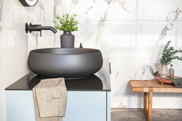 Oval mirror over black sink in stylish bathroom interior, black countertop.