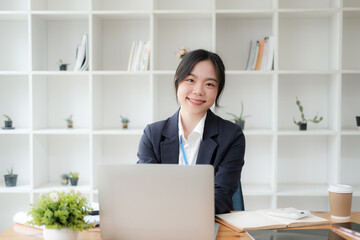 Young Adorable Asian businesswoman working in the office room with laptop computer.