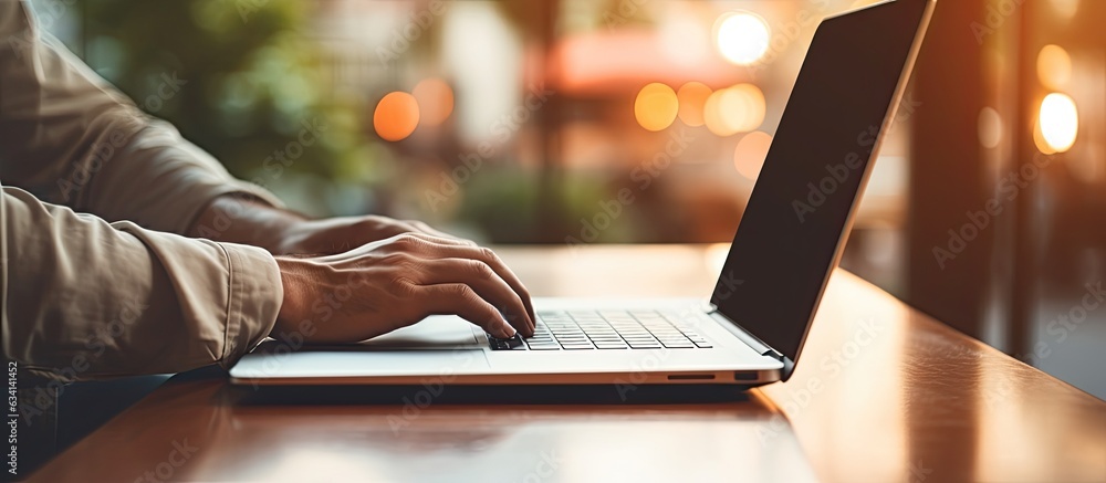 Aufkleber Man using laptop with empty screen for advertising text message in office